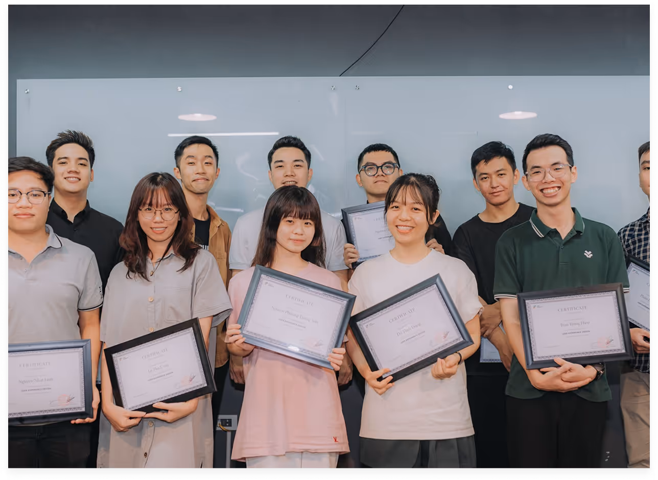 a group of people holding certificates