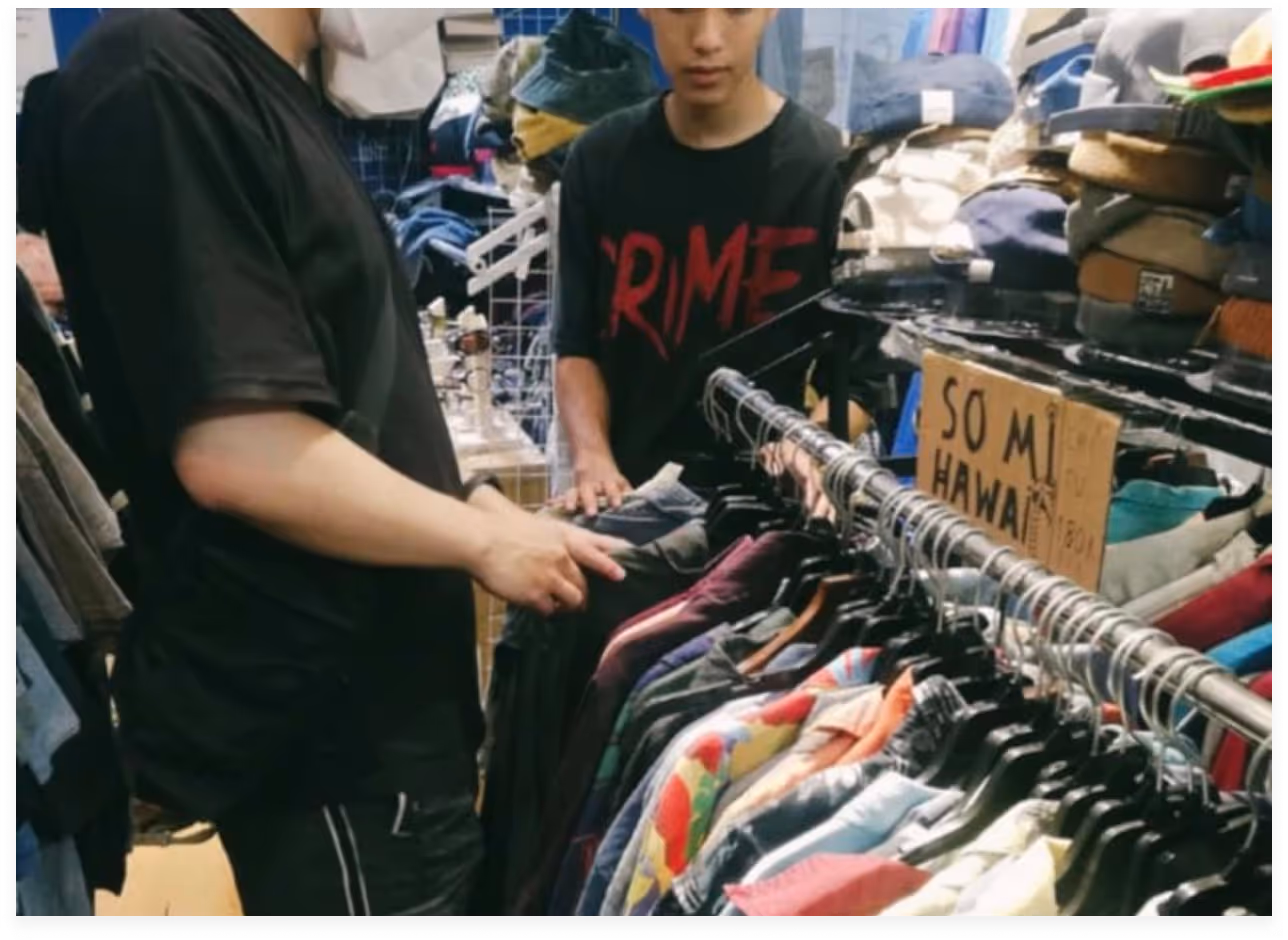 a man holding a shirt on a swinger