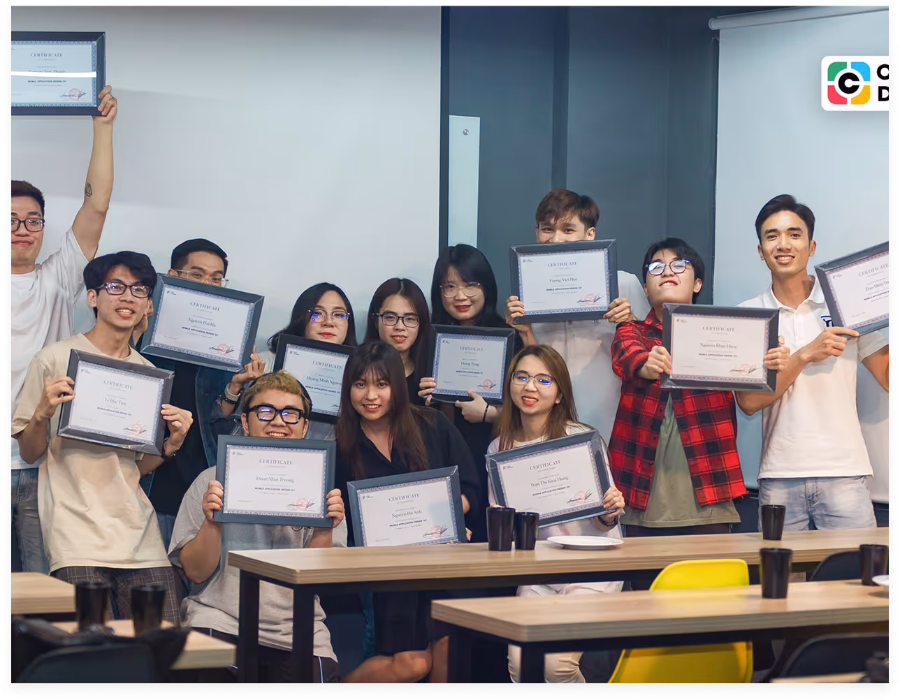 a group of people holding up certificates