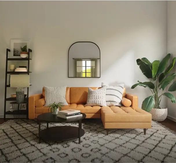 Modern living room with orange sofa, patterned rug, and indoor plants