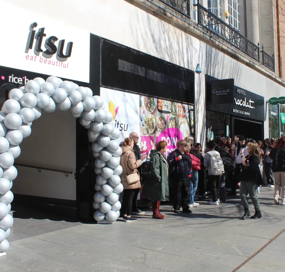 Itsu storefront with customers queuing up