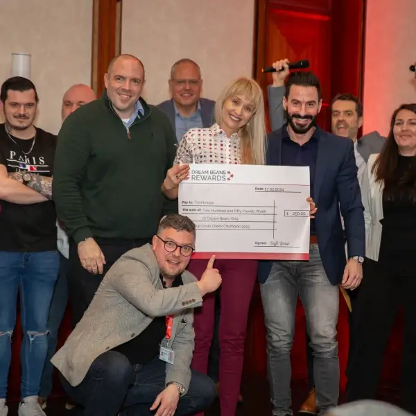 Scoffs team posing with charity cheque for £250