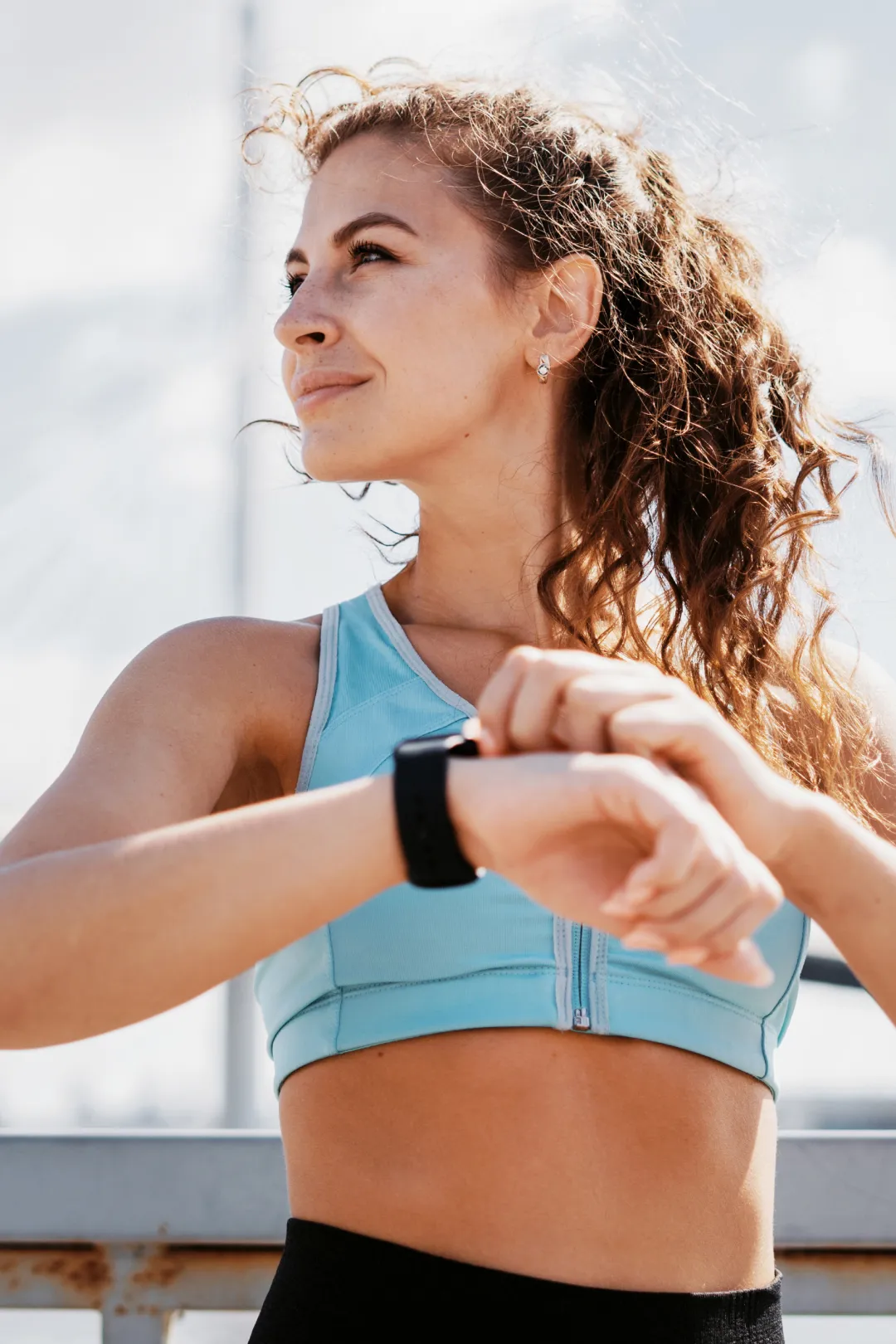 Sportive consultant sa montre connectée pendant son entraînement en extérieur