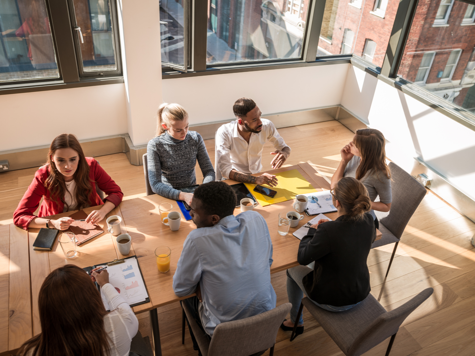 a group of people sitting around a table