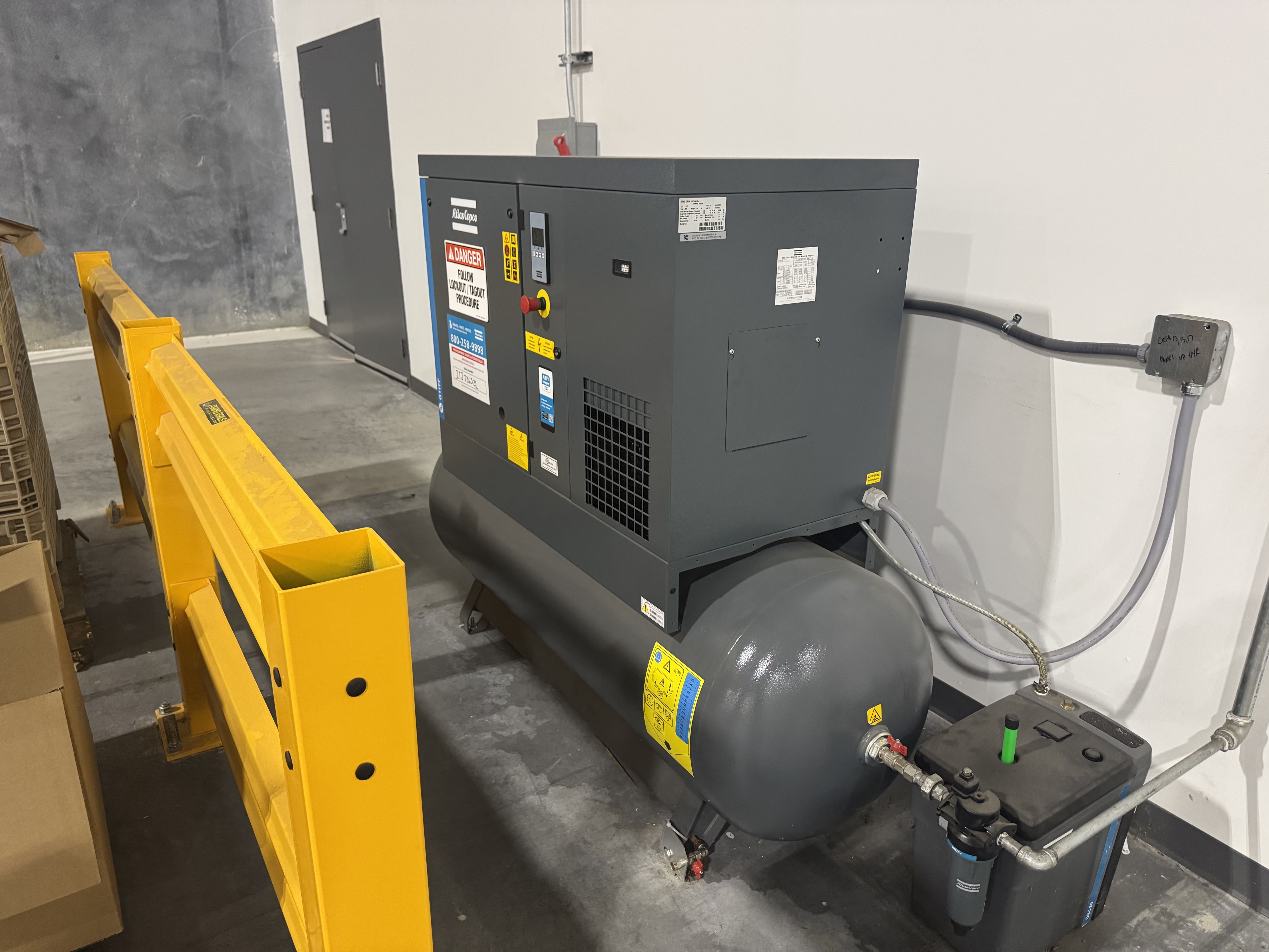 rotary screw air compressor installed inside an industrial building