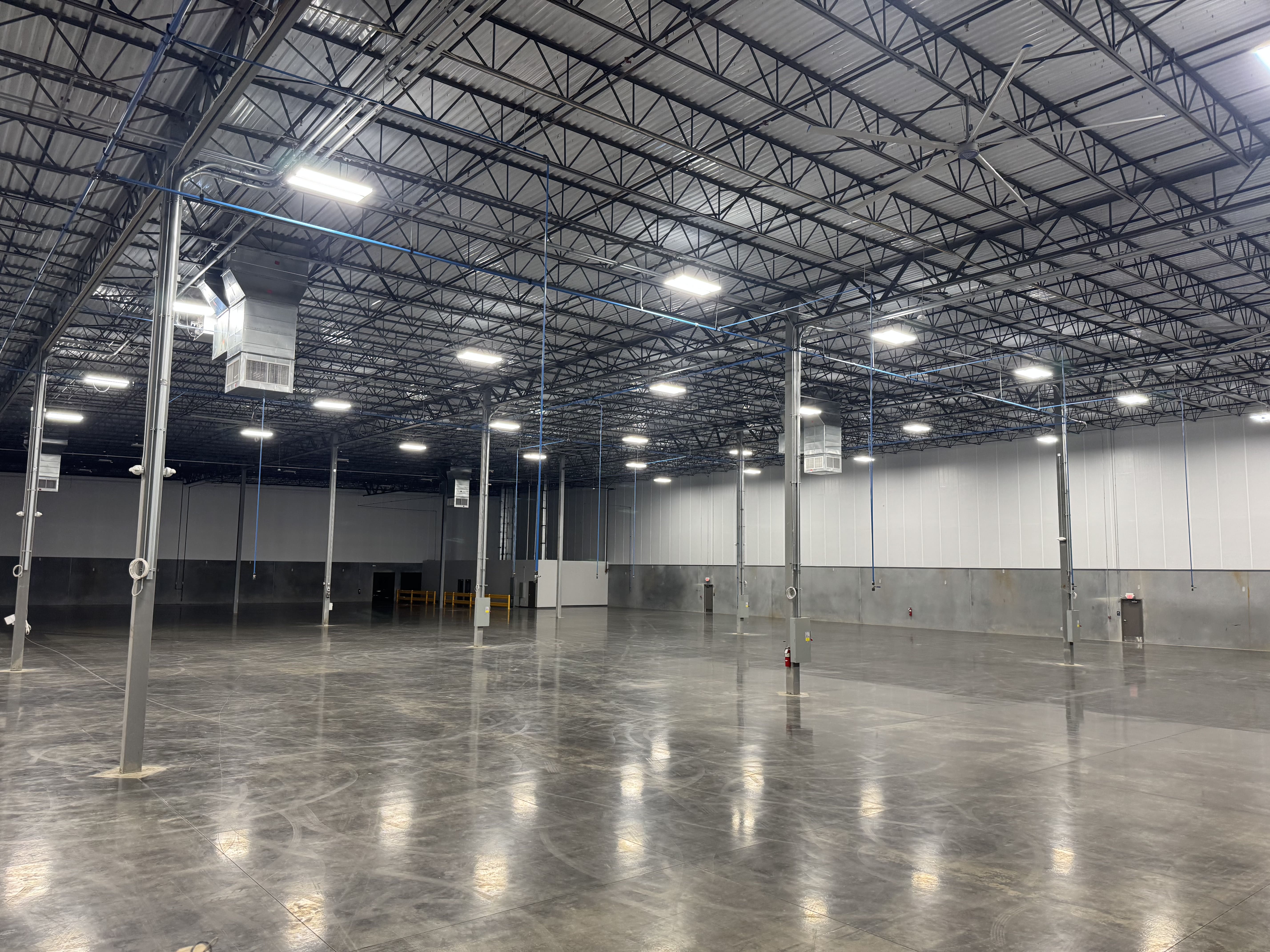 custom installed LED lighting inside an open industrial warehouse