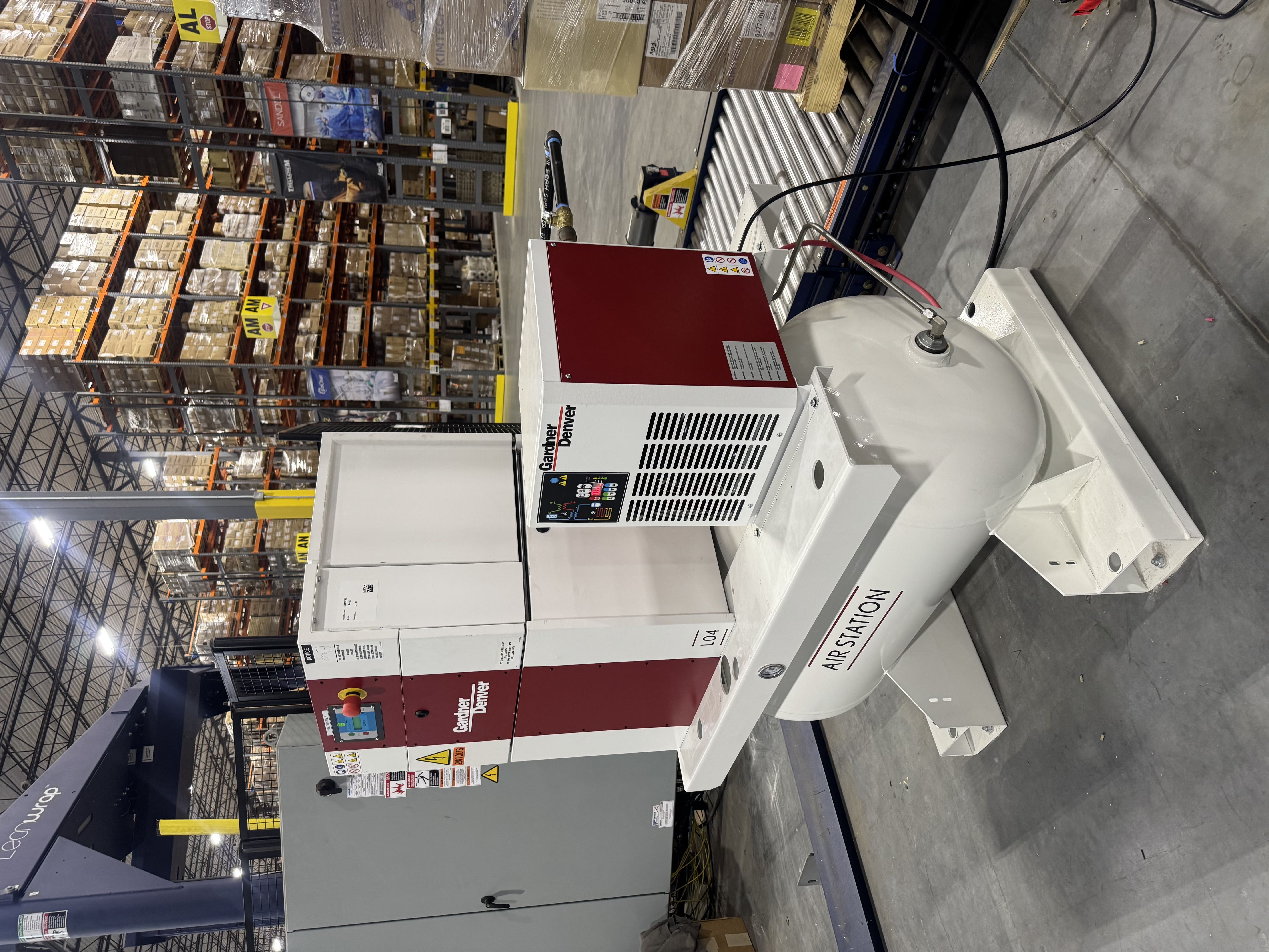 BM Industrial Solutions air compressor system installed inside an industrial warehouse facility