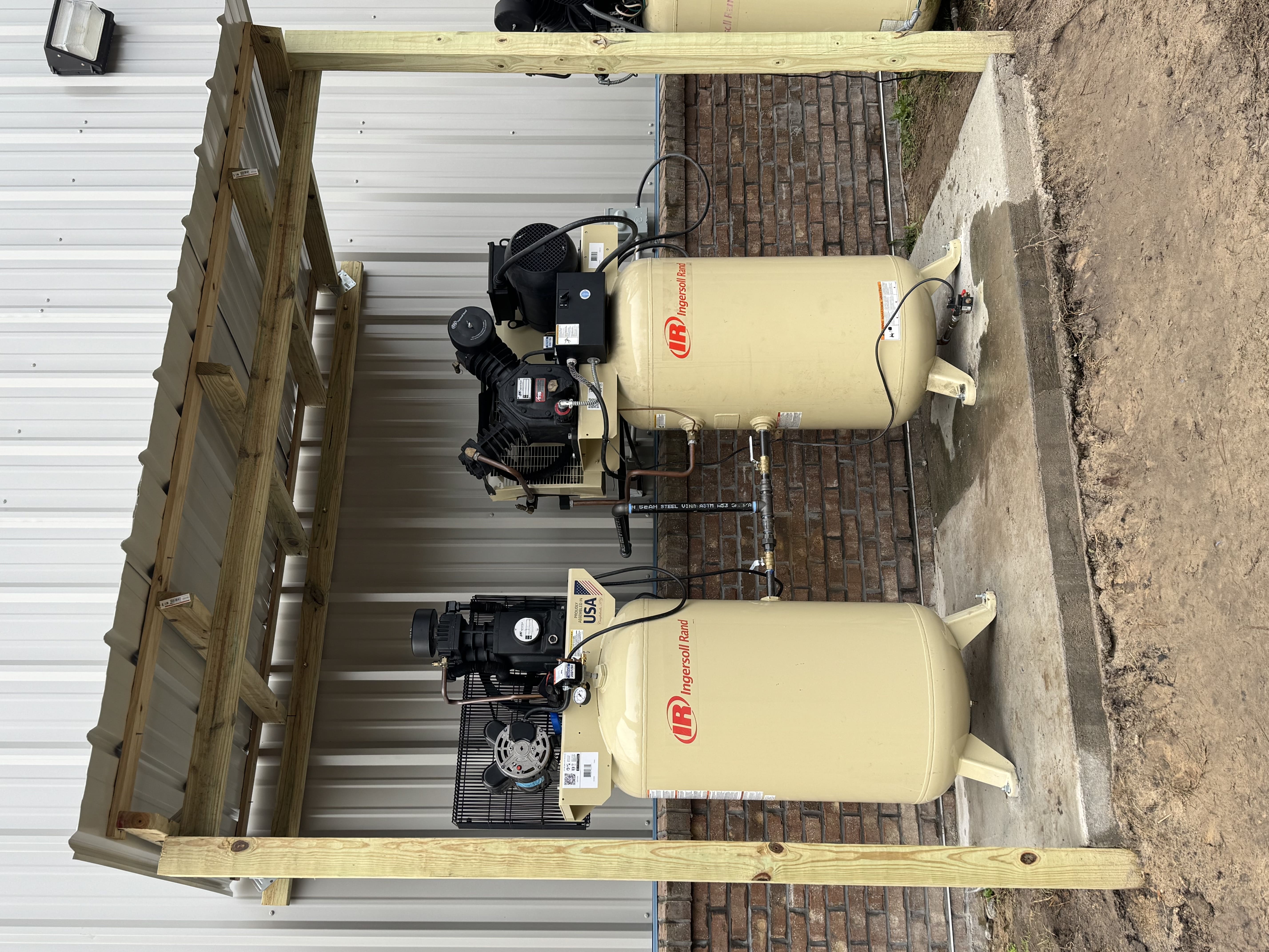 dual air compressors outside a commercial facility