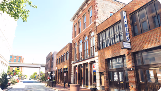Historic brick downtown street with vintage buildings and Fisher's sign