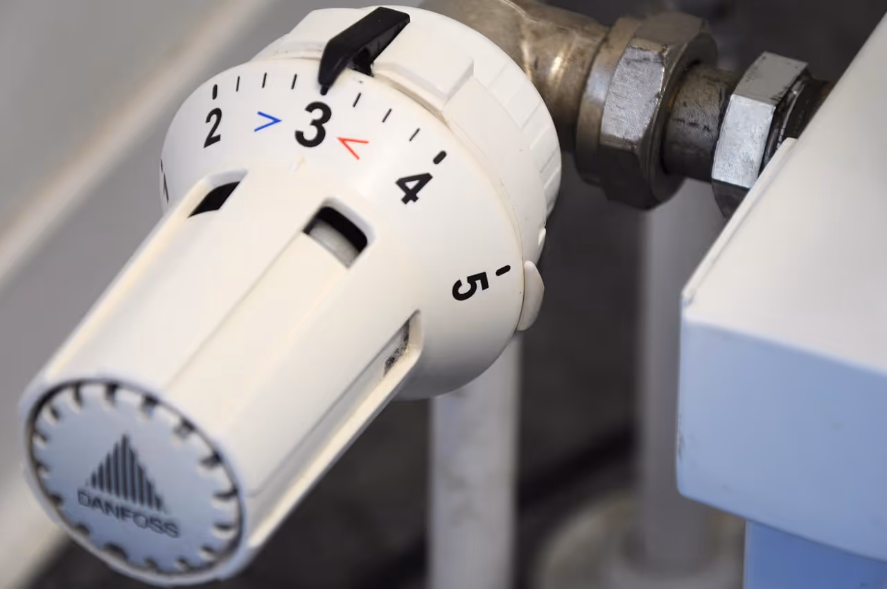 White Danfoss radiator thermostat with numbered temperature settings