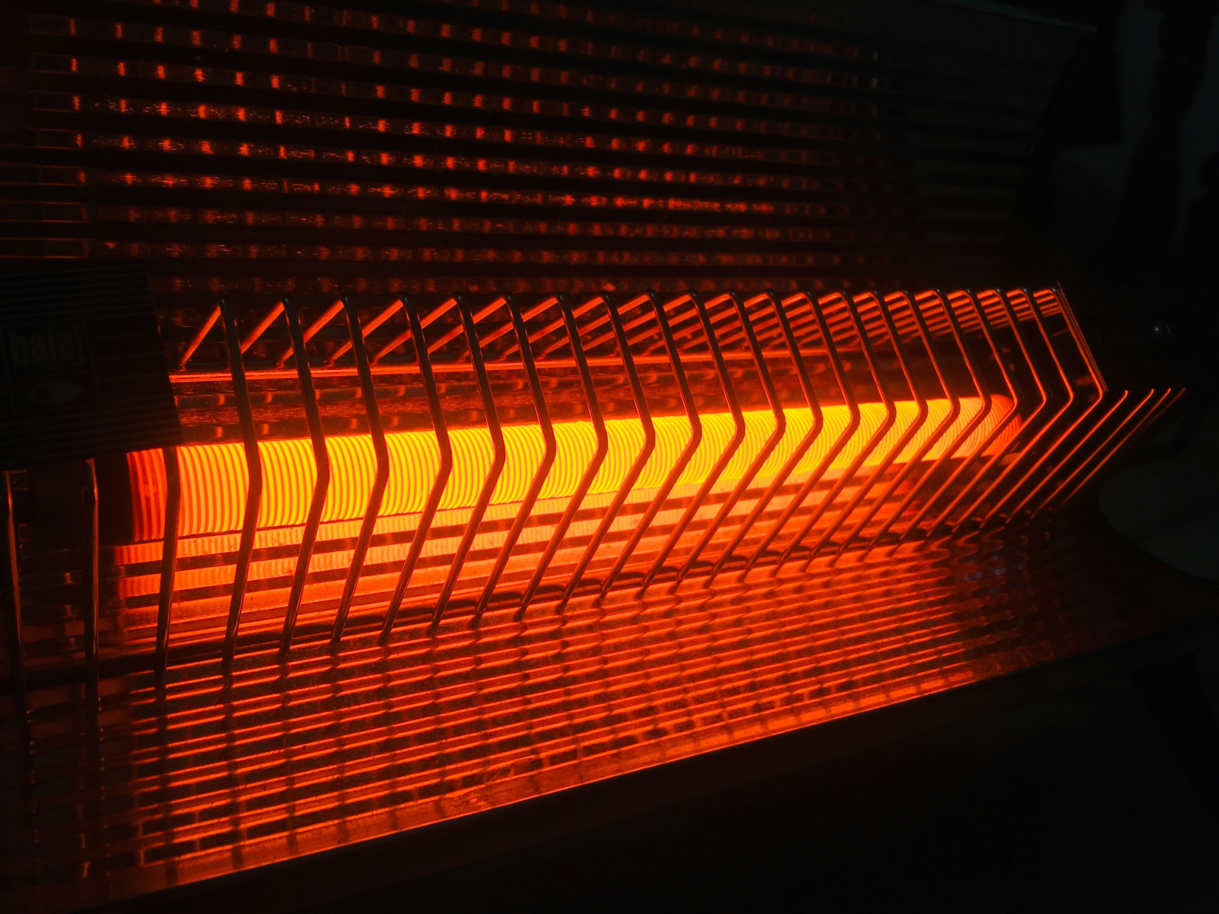 Glowing orange electric heater with geometric pattern radiating warmth