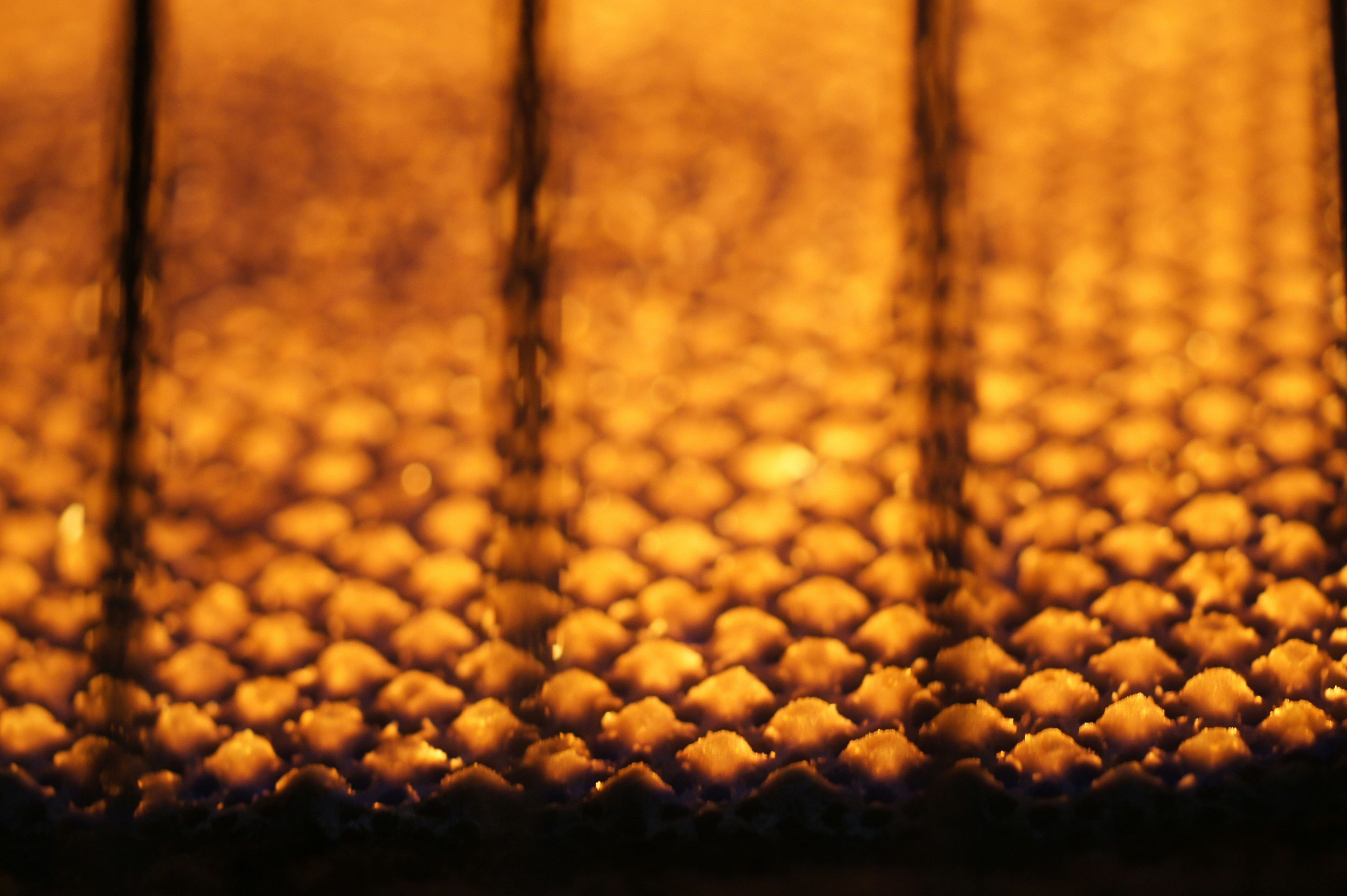 Golden honeycomb pattern with warm, glowing amber-colored hexagonal cells