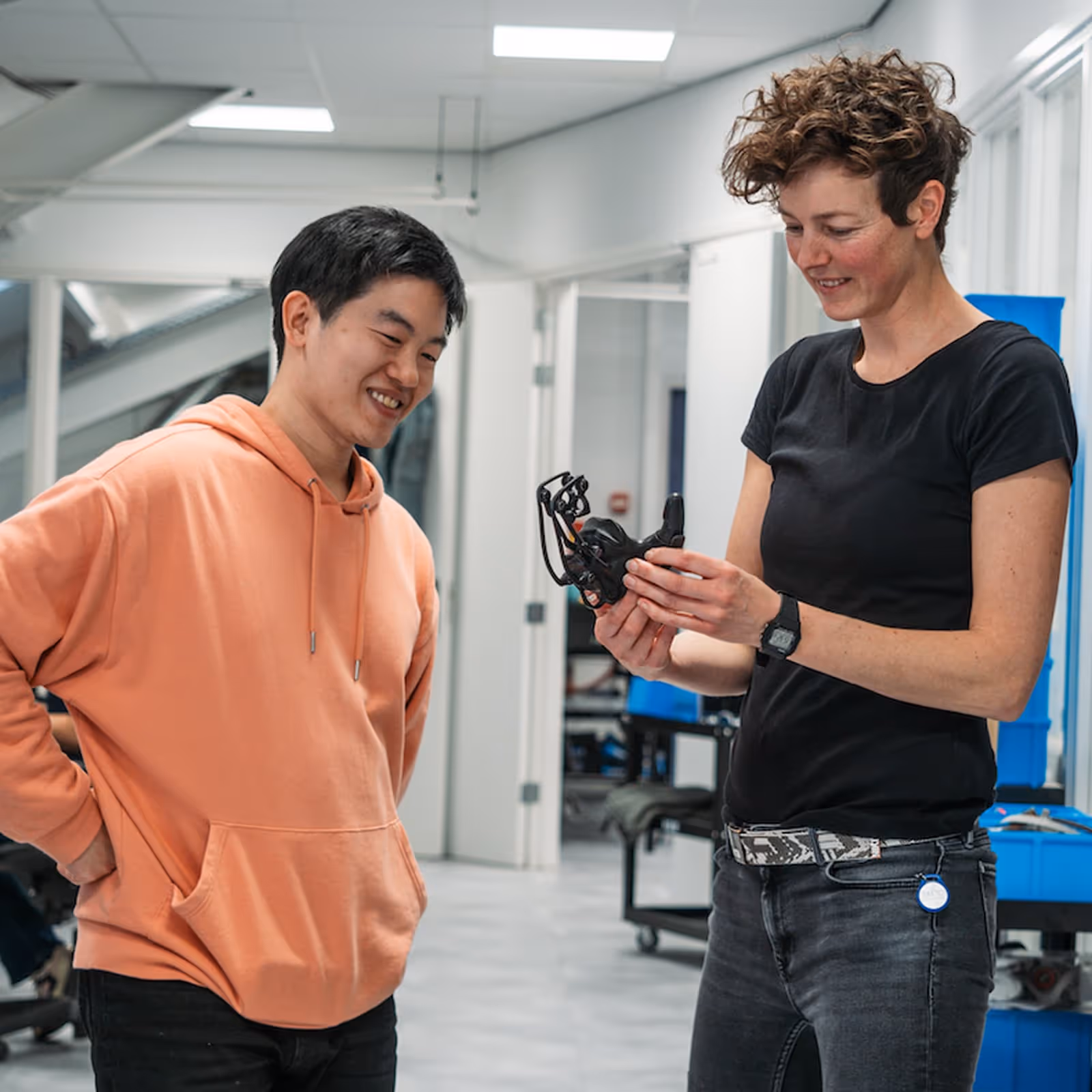 Manometric employees collaborating and reviewing a prototype device in the office.
