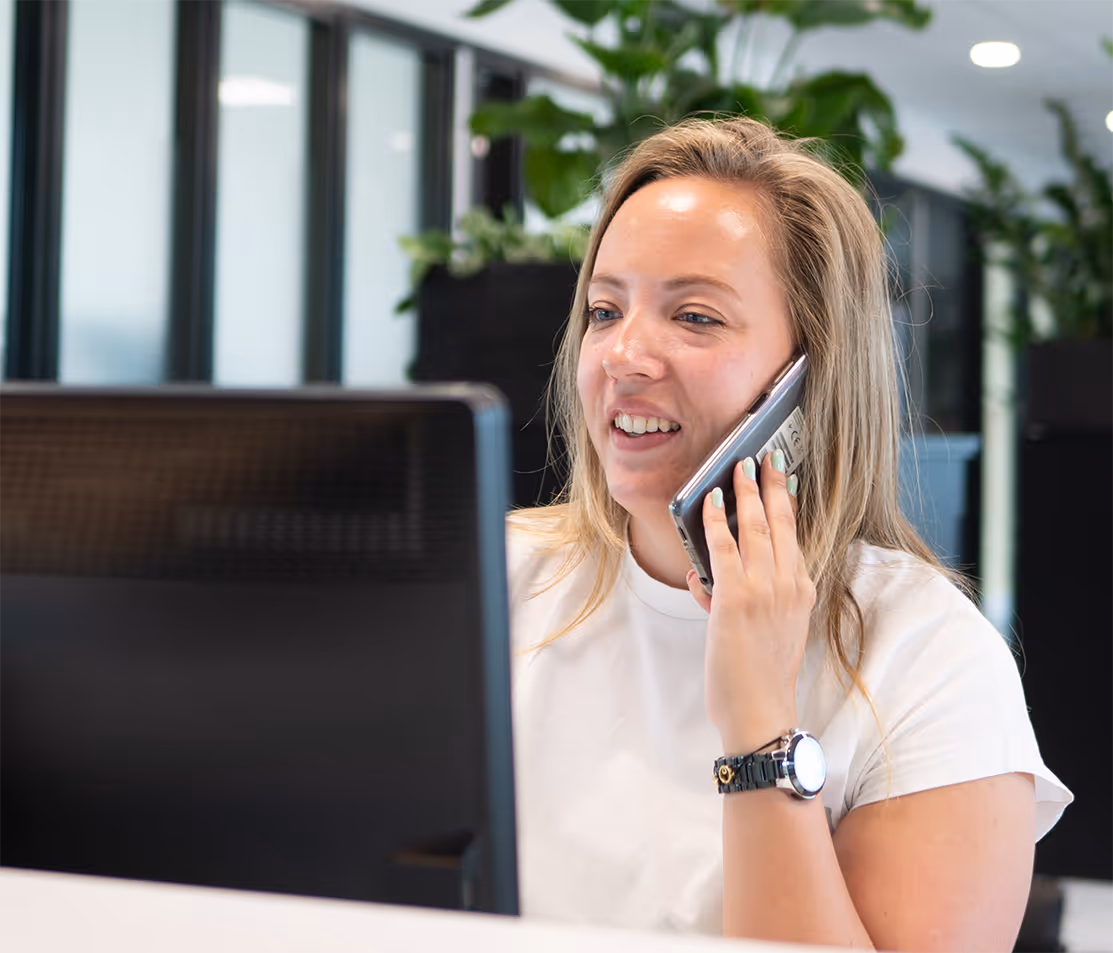 Manometric employee at the office reception desk speaking on the phone.