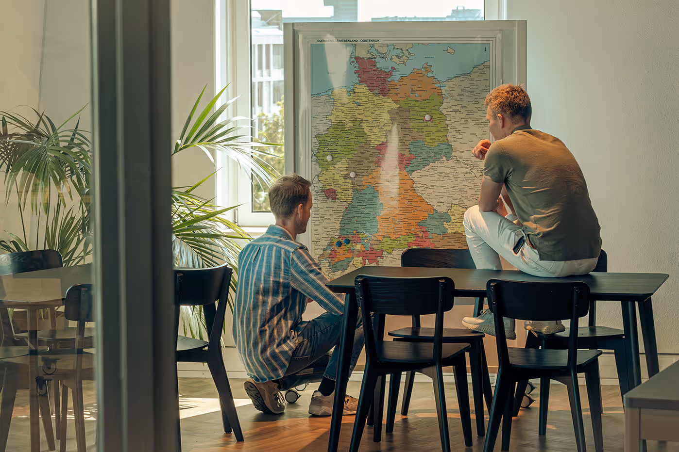 Manometric employees planning expansion while looking at a map of Germany.