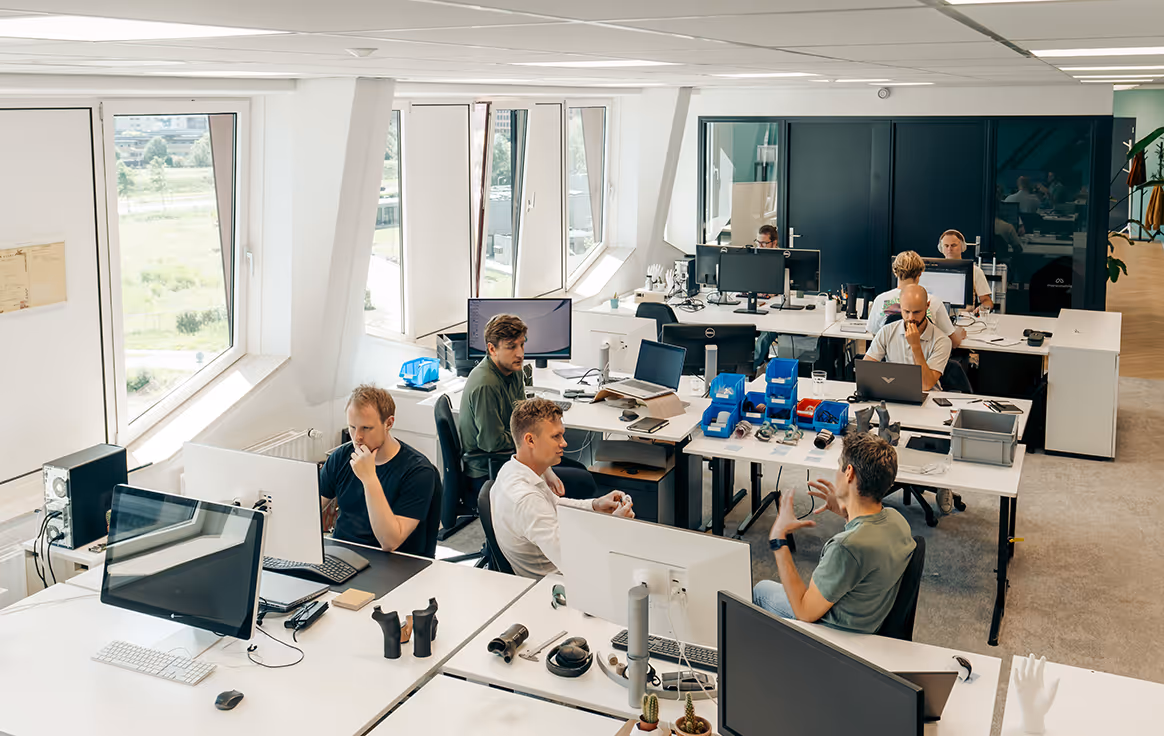 Manometric employees working together in an open office space.