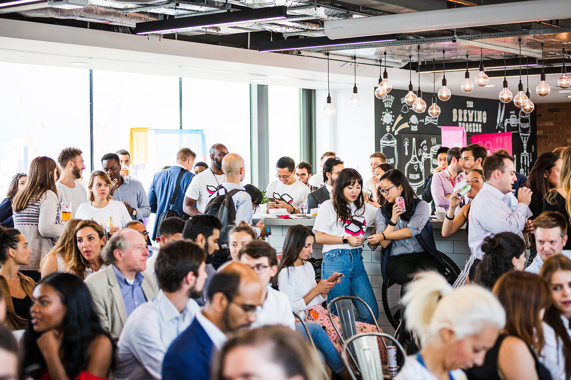 A group of people socialising with drinks at a Finimize event.