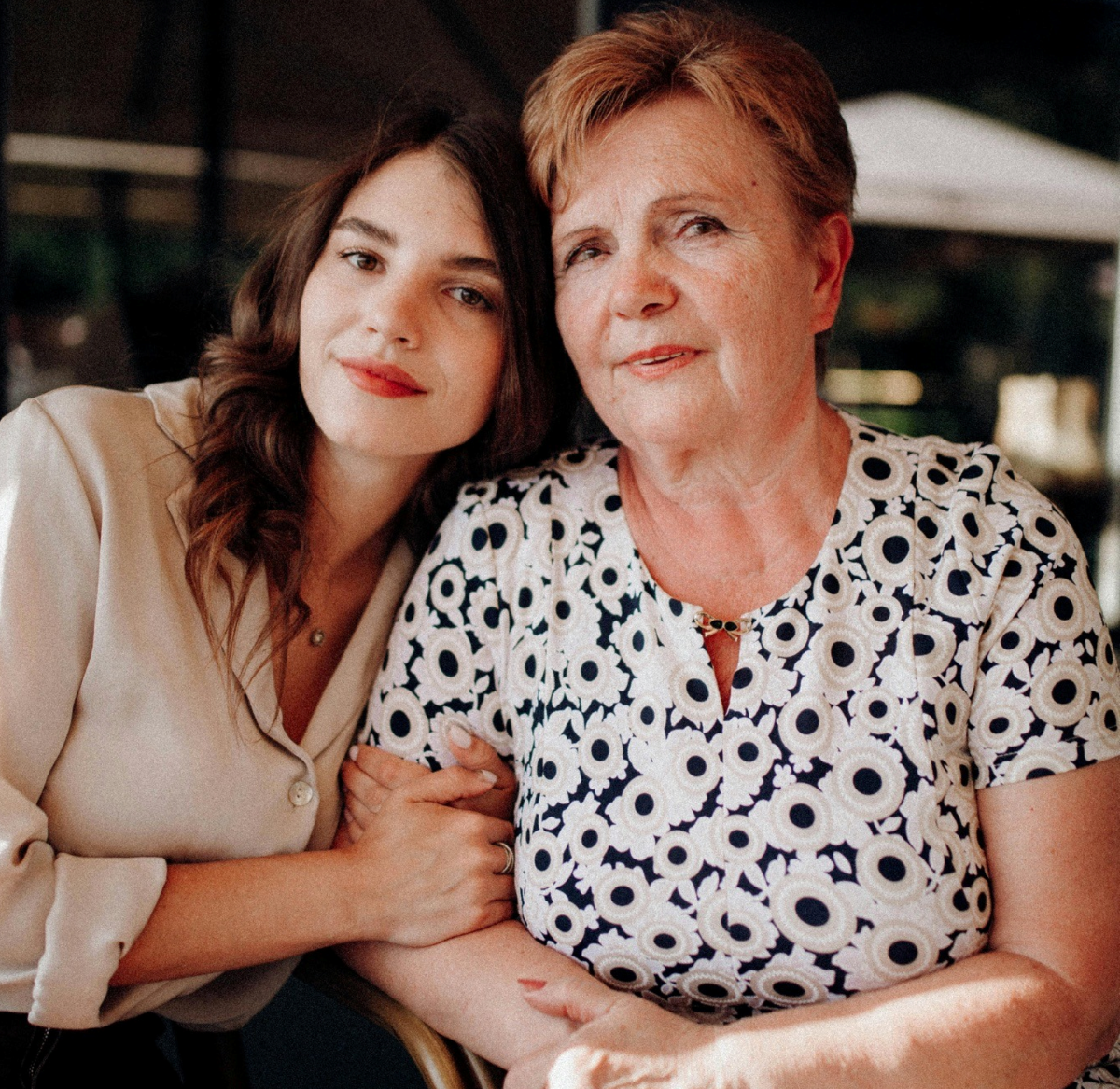 a woman on top of a grassy mountain range