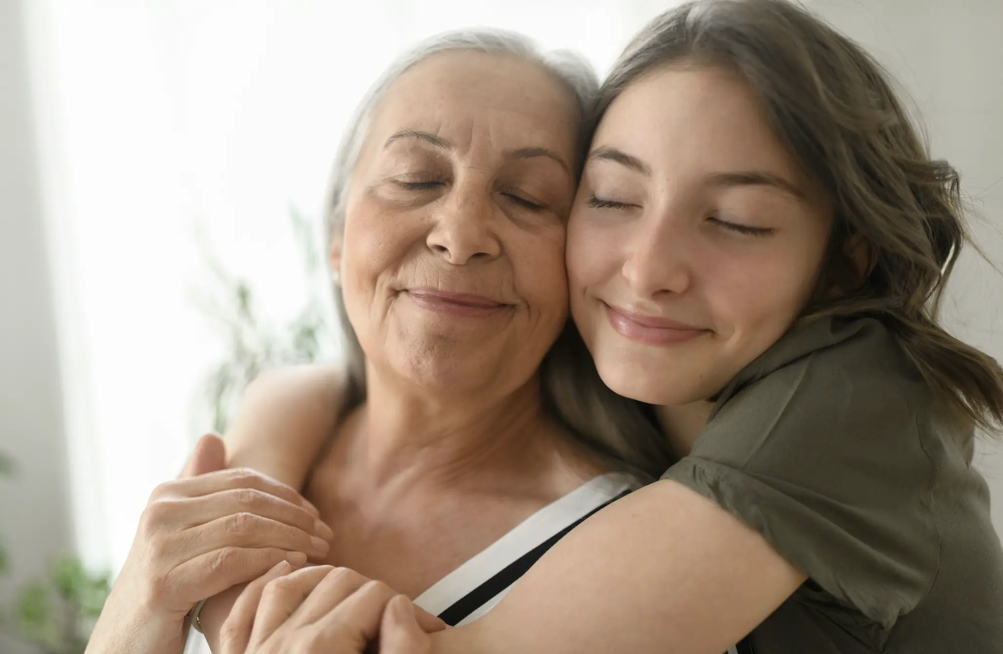 older woman and younger woman embracing