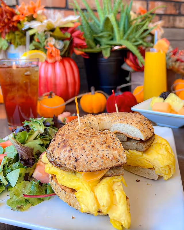 Two sandwiches with eggs and cheese on a plate.