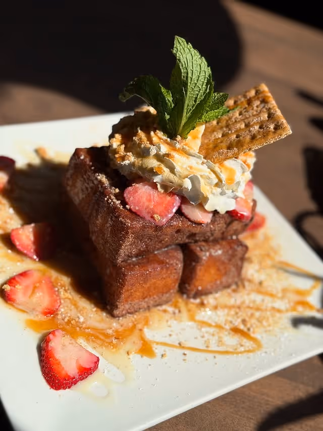 A plate of food with a strawberry on top.