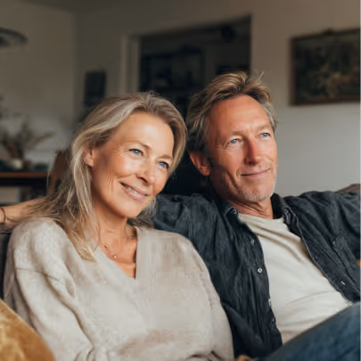Couple on a couch smiling