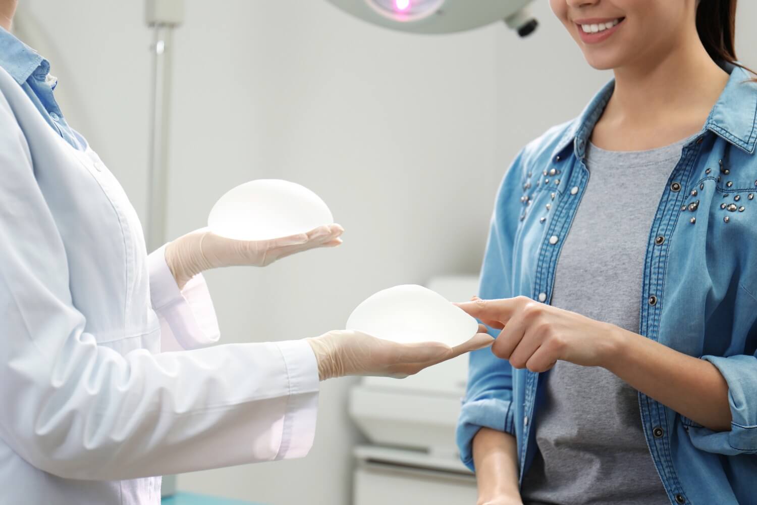 Woman consulting with cosmetic surgeon about breast implants.