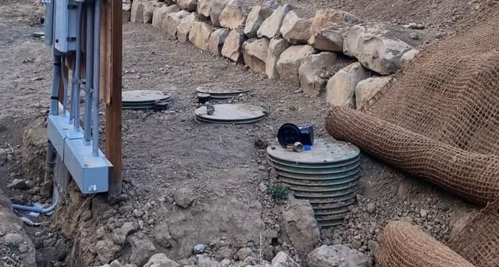 Installed septic tank risers and lids on an IVR EarthWorks septic install