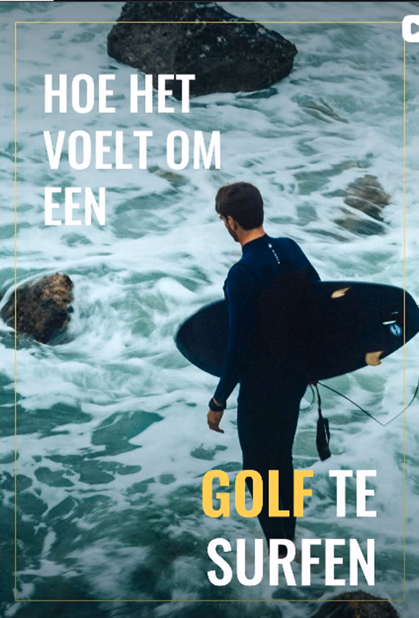 Surfer in wetsuit holding a black surfboard looking at rocky waves in the ocean.