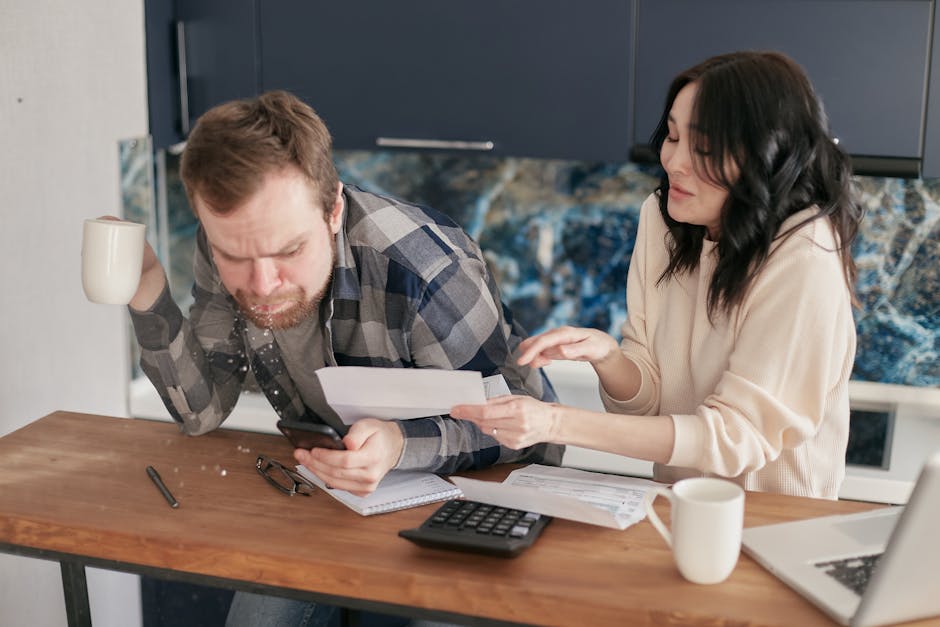 person looking at an electricity bill with a calculator - does cleaning solar panels make a difference