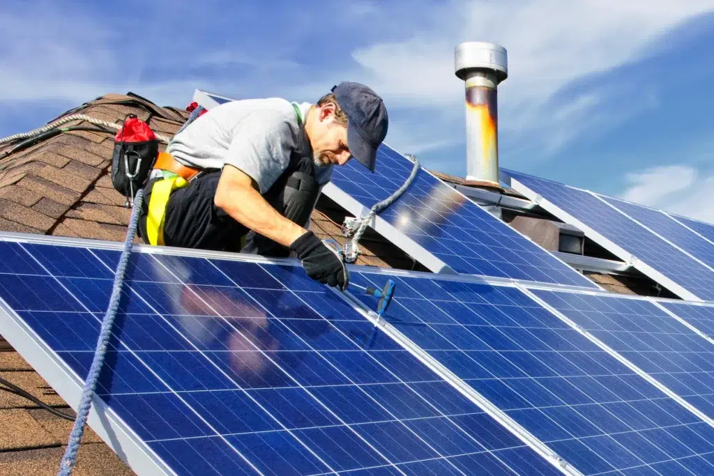 Professional technician installing solar panels on a residential roof in Chula Vista, California, emphasizing sustainable energy solutions and home value enhancement.