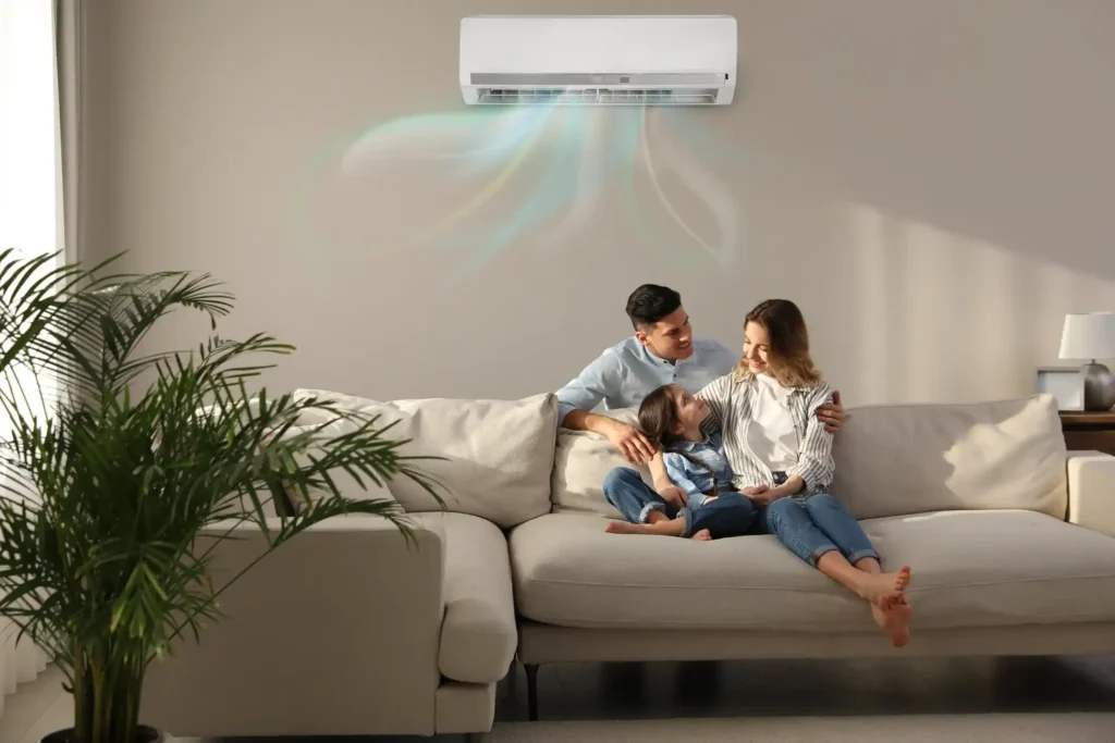 Family enjoying comfortable indoor air quality with air conditioning unit in a cozy living room, emphasizing health and well-being.