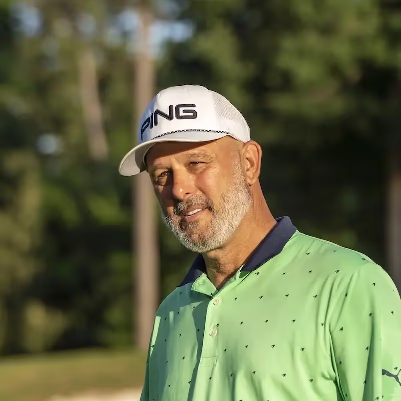 Man wearing a PING hat on the golf course