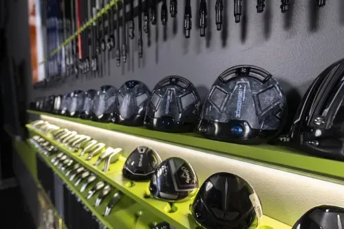 GOLFTEC center showcasing a variety of driver heads from top brands