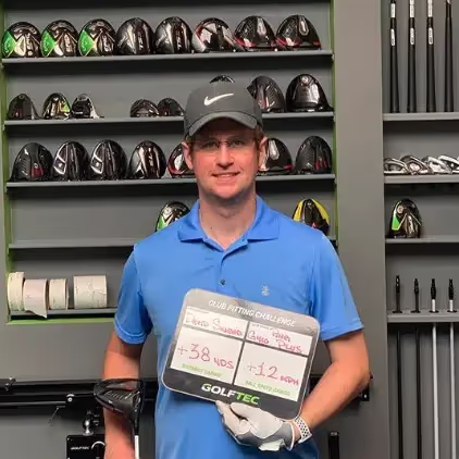 Male GOLFTEC student showcasing club fitting improvements