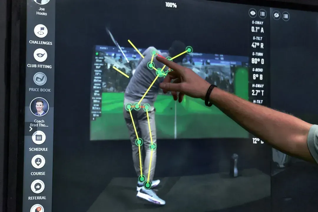 GOLFTEC coach breaking down a students golf swing using OptiMotion