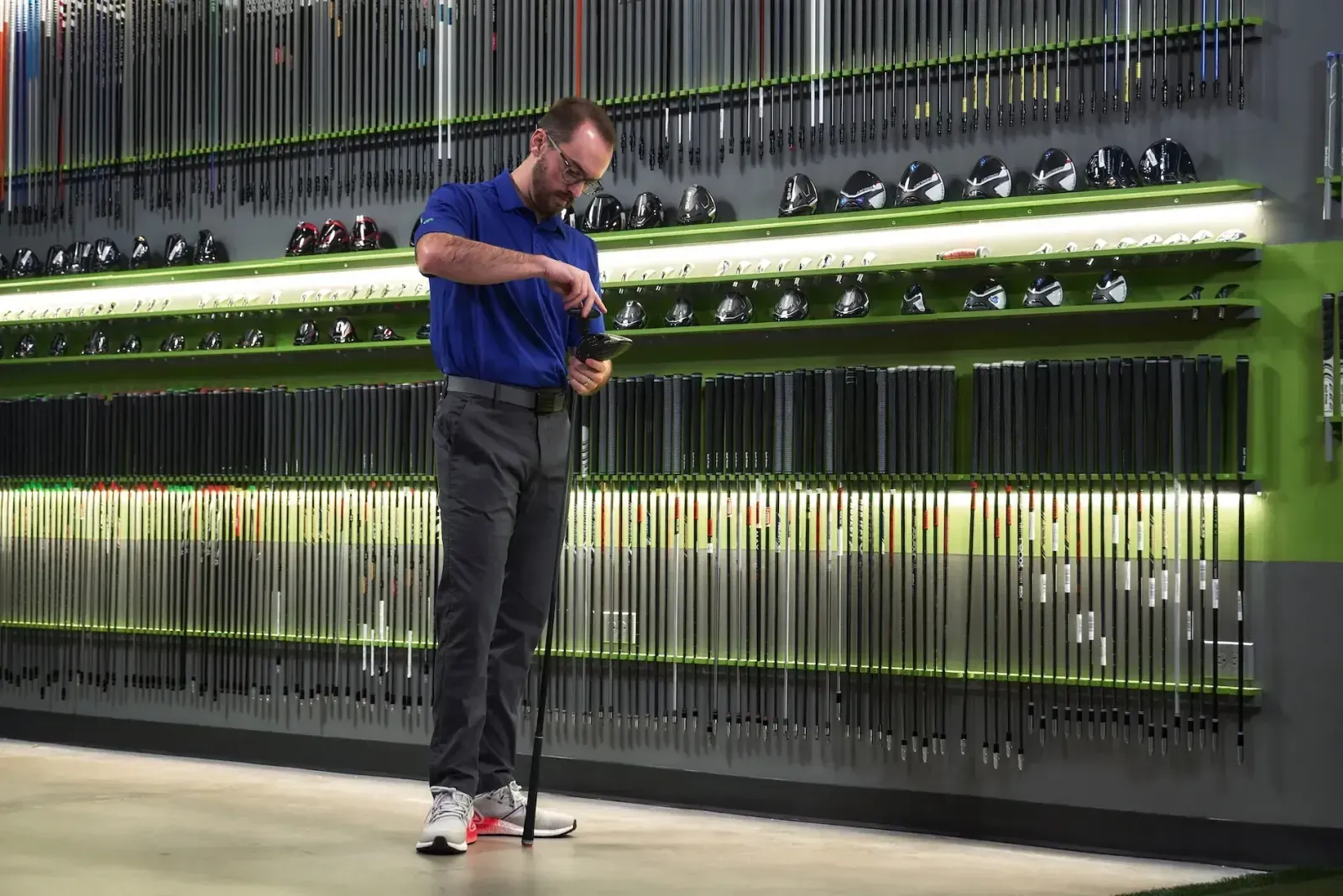 GOLFTEC coach adjusting club head to a shaft for student