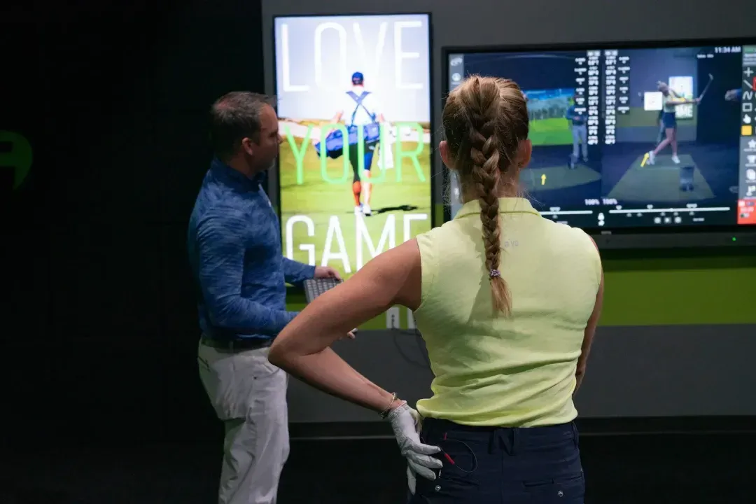 Coach and student using OptiMotion for swing analysis at a GOLFTEC Center