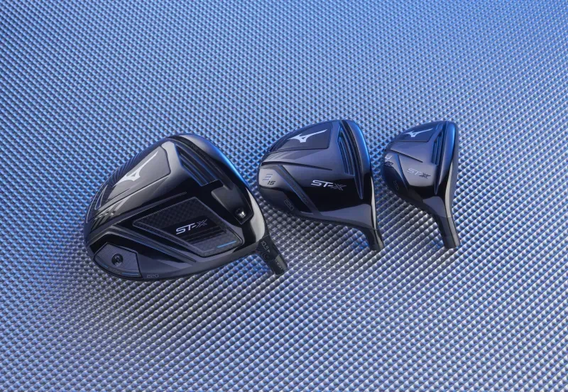 Mizuno ST MAX 230 driver, fairway wood, and hybrid clubheads on a metallic surface 