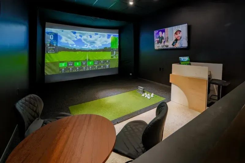 Inside a GOLFTEC Golf Simulator Bay in a golf store.