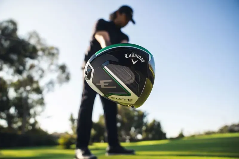 Close-up view of the Callaway Elyte driver clubhead with a golfer positioned to hit the ball from the tee box. 