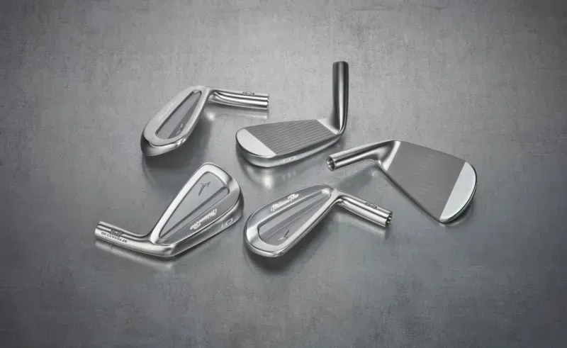 Mizuno PRO S-3 iron heads scattered on a grey surface. 