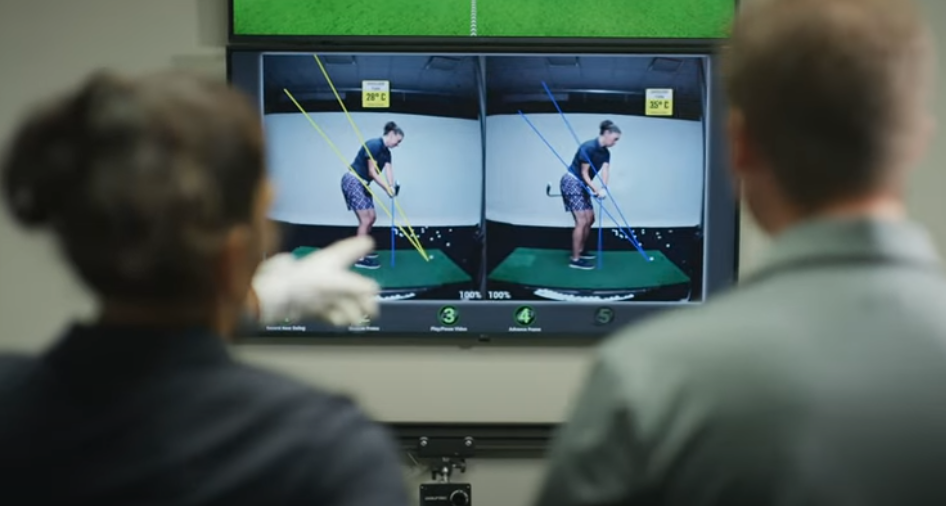 Coach and student reviewing swing analysis with OPTIMOTION. .