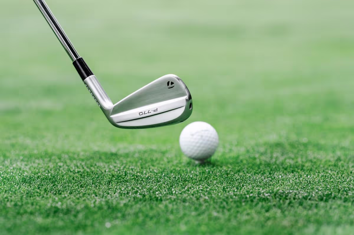 TaylorMade P770 iron ready to hit golf ball on the fairway.