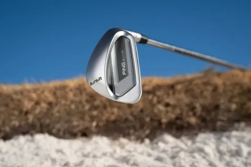 Close-up of a PING BunkR Sand Wedge inside the bunker.