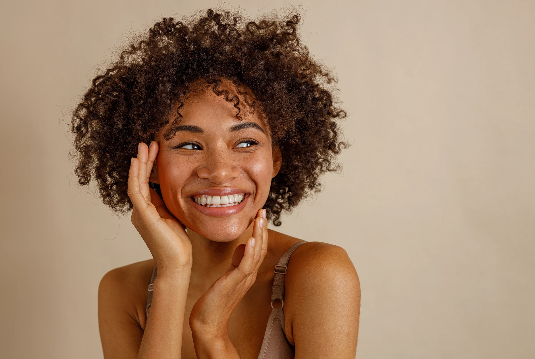woman smiling touching face