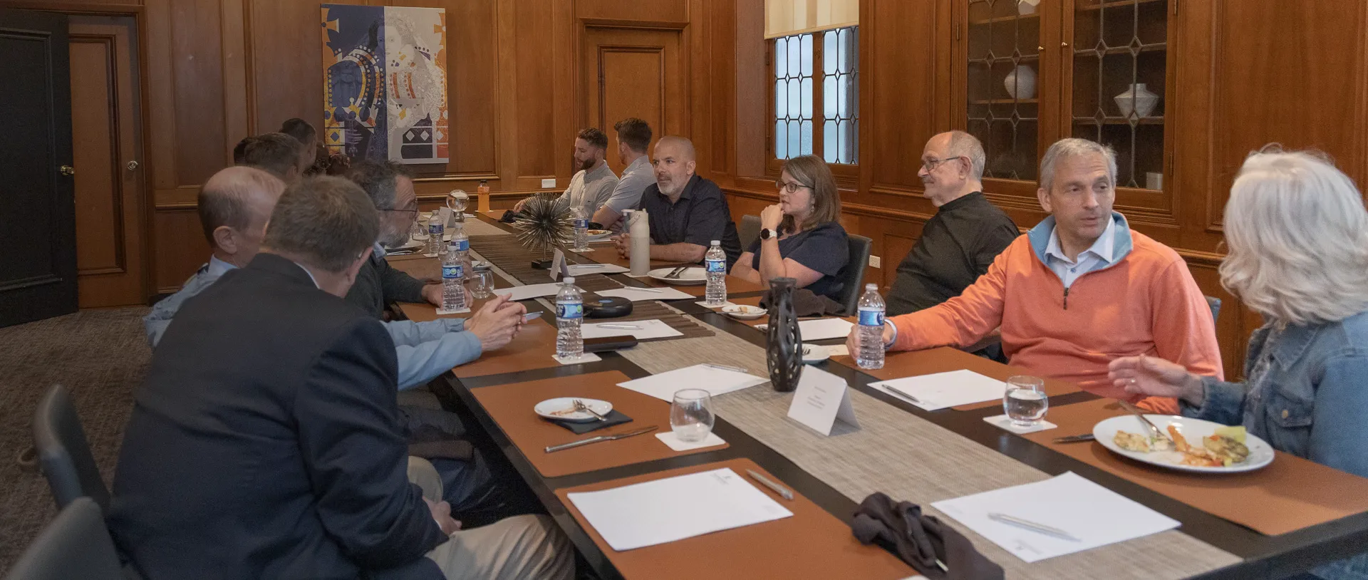 branches worldwide partners meetings at a long table