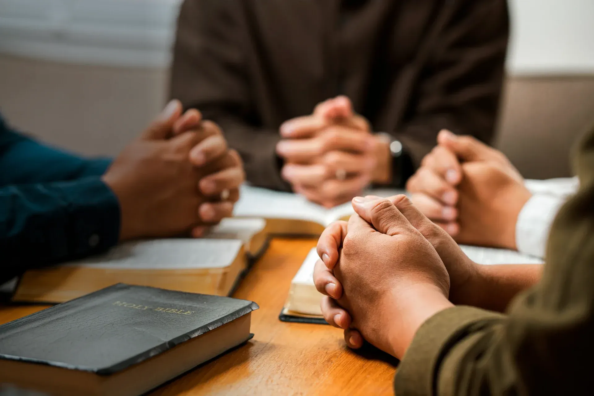branches around table with hands folded