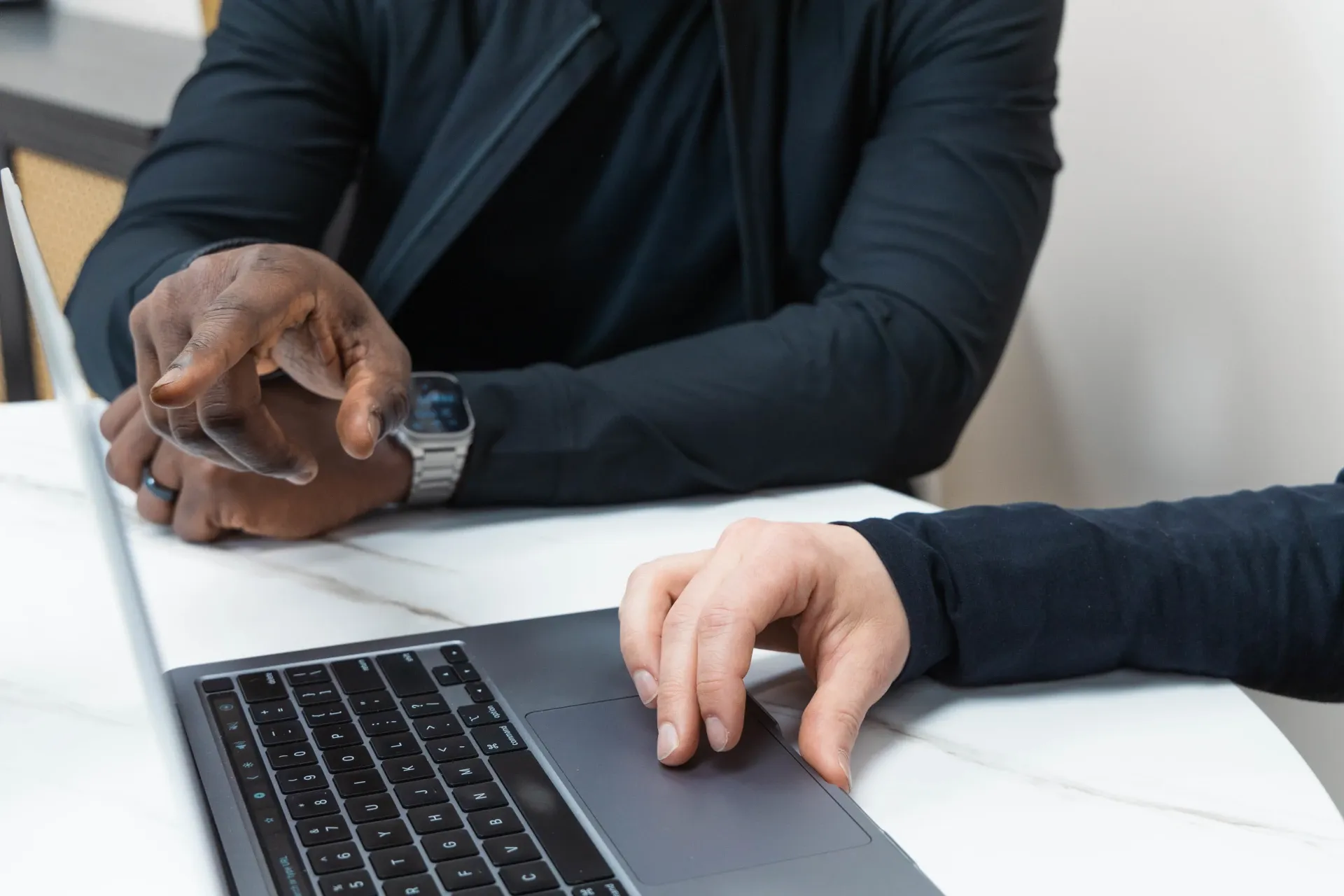 hands in front of a laptop