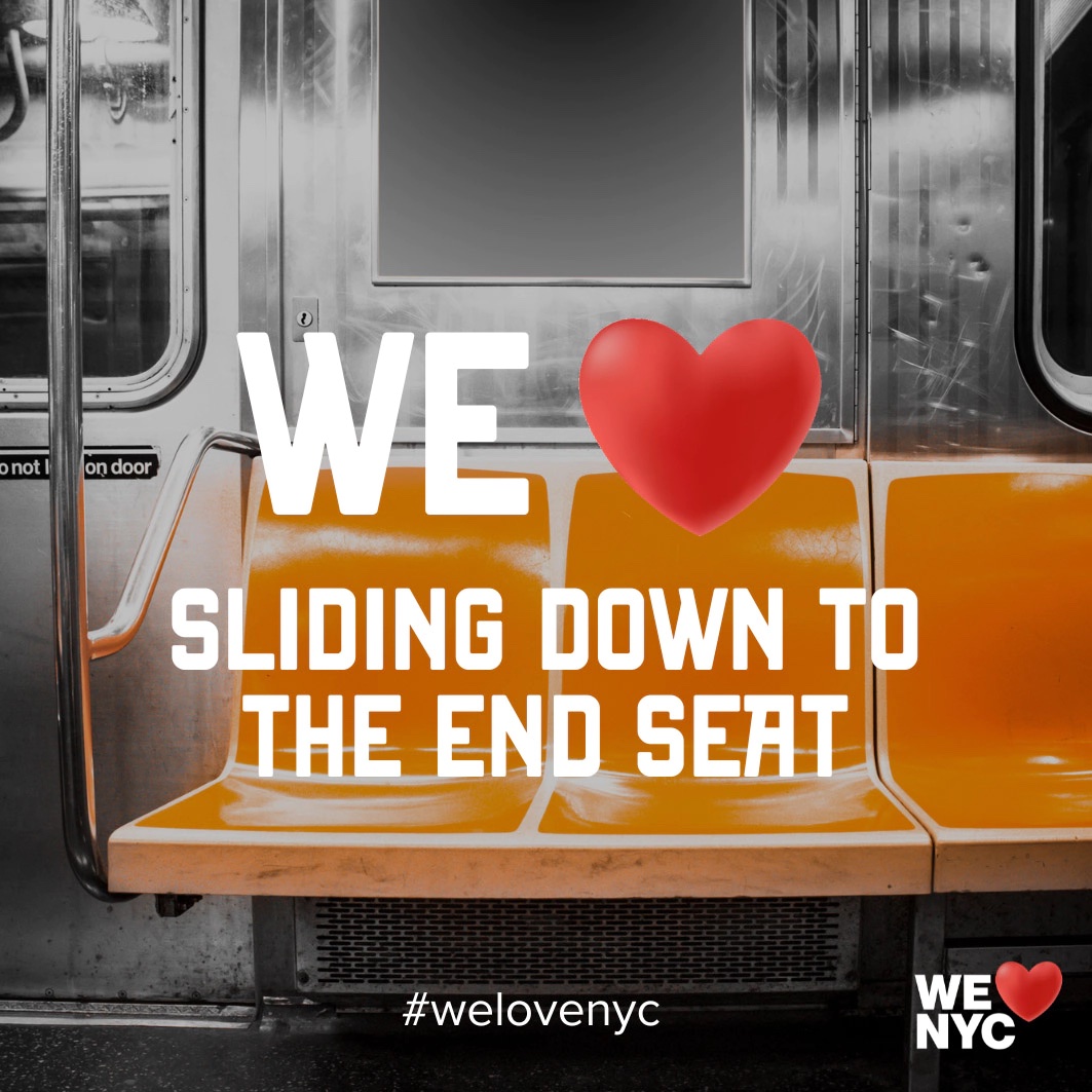 An image of empty orange seats on a NYC subway car with the words "WE [heart] SLIDING DOWN TO THE END SEAT" centered over the image.